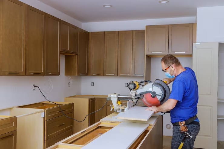 A person using a circular saw in a kitchen AI-generated content may be incorrect.